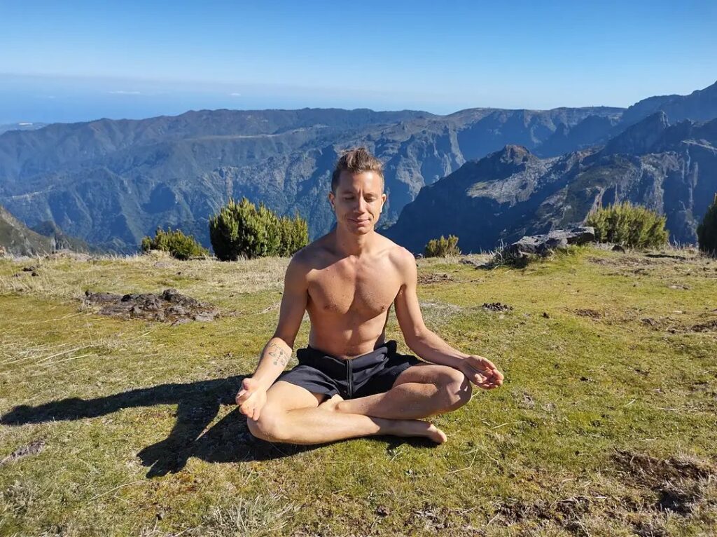 man doing meditation in nature
